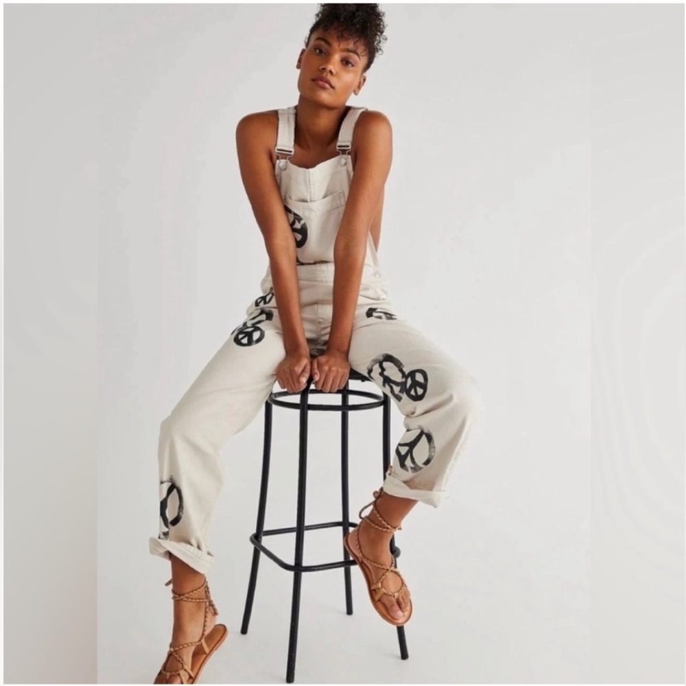 RARE We The Free cream overalls with black peace signs 
Size small.